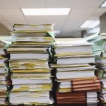 stack of paperwork in an office setting